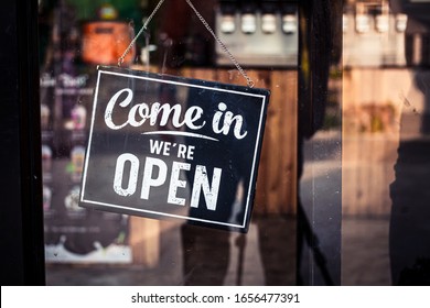 Come in we're open, vintage retro sign in cafe front - Shutterstock ID 1656477391
