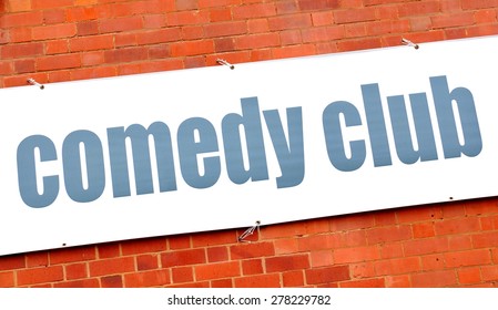 Comedy Club Sign Against Red Brick Wall