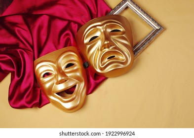 Comedy and tragedy masks with purple drapery.
