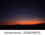 Comet c2023 A3, or Tsuchinshan-ATLAS, seen in the late evening sky overlooking the Coconino National Forest outside of Flagstaff, Arizona 