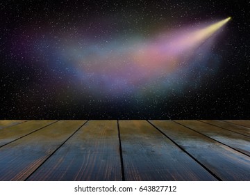 Comet flies in the darkness of outer space and wooden boards