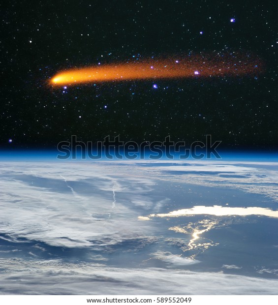 Comet flying above the earth
globe. Comet impact. 