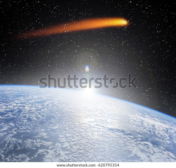 Comet flying above the earth\
globe. Comet impact. \