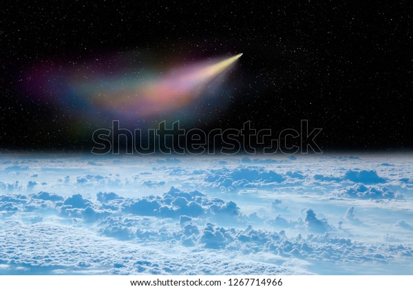 Comet flying in space over\
white clouds. Comet flying in space over planet Earth. Space\
landscape. Starry sky with falling comet above surface of Earth.\
View of clouds over Earth from space.Elements of this image\
furnished by nasa