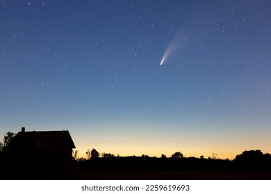 Comet NEOWISE graces the sunset above a ruined farm house in Southern Ontario, Canada, July 17, 2020. - Shutterstock ID 2259619693
