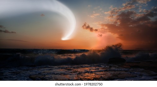 Comet on the sky with amazing sunset over the stormy sea