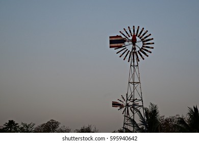 Comet Windmills In Red, Blue And White On Smoggy Sky In The North Of Thailand