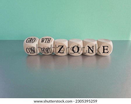Comfort or growth zone symbol. Turned wooden cubes and changes words 'comfort zone' to 'growth zone'. Beautiful gray table, blue background, copy space. Business, psychology concept.