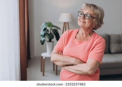 Comfort relaxed senior old elderly woman grandmother at home looking at camera in the living room. Pension concept. - Powered by Shutterstock