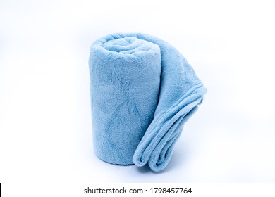Comfort Rolled up blue coral fleece throw isolated on white background