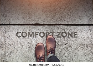 Comfort Zone Concept, Male With Leather Shoes Steps Over A Word With Line On Concrete Floor, Top View