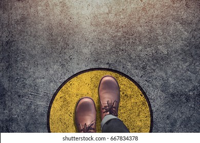 Comfort Zone concept, Male with leather shoes steps over circle line to outside bound, Top view and Dark tone, Grunge Dirty Concrete Floor as Background - Shutterstock ID 667834378
