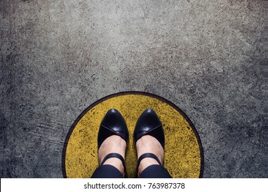 Comfort Zone Concept, Woman with leather shoes Standing inside a Circle Bound, Top view and Dark tone, Grunge Dirty Concrete Floor as Background - Powered by Shutterstock