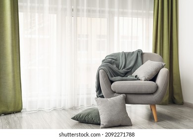 Comfortable armchair near light curtains in room - Shutterstock ID 2092271788