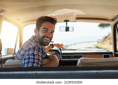 Comfortable back there. Rearview portrait of a handsome man enjoying a summer roadtrip.