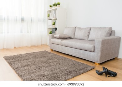 comfortable beautiful living room with business woman high heel shoes.
