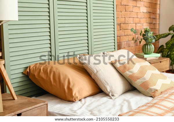 Comfortable bed near folding\
screen
