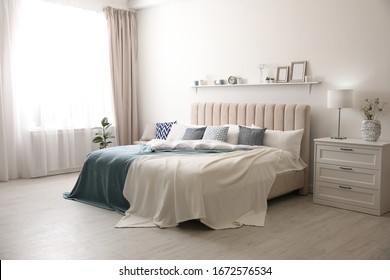 Comfortable Bed With Pillows In Room. Stylish Interior Design