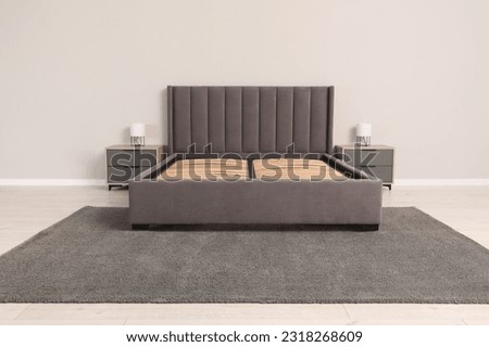Comfortable bed with storage space for bedding under slatted base in room