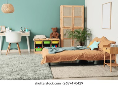 Comfortable bed, table and closet in interior of children's room