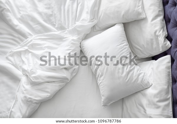 Comfortable bed with white\
linen at home