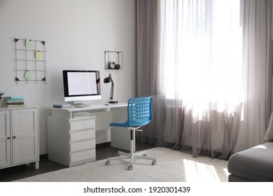 Comfortable Blue Chair Near Desk In Stylish Office Interior