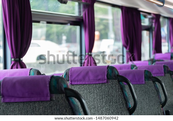 Comfortable\
bus seats backs without passengers. Intercity coach services. New\
bus interior with seat belts on each\
place.