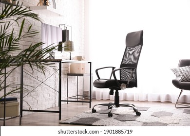 Comfortable chair near desk in modern office interior - Shutterstock ID 1901885719