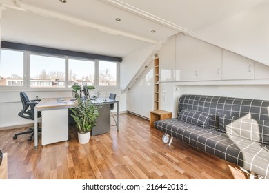 Comfortable Chair Placed Near Table With Computer Monitors Against Blank Whiteboard And Mirror In Light Home Office In Contemporary Flat