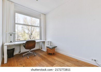 Comfortable Chair Placed Near Table With Blank Whiteboard And Mirror In Light Home Office In Contemporary Flat