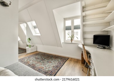 Comfortable Chair Placed Near Table With Computer Monitors Against Blank Whiteboard And Mirror In Light Home Office In Contemporary Flat