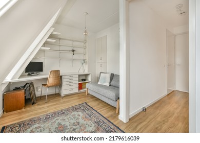 Comfortable Chair Placed Near Table With Computer Monitors Against Blank Whiteboard And Mirror In Light Home Office In Contemporary Flat