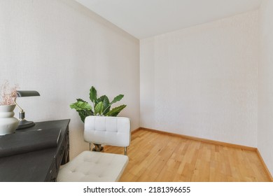 Comfortable Chair Placed Near Table With Against Blank Whiteboard And Mirror In Light Home Office In Contemporary Flat