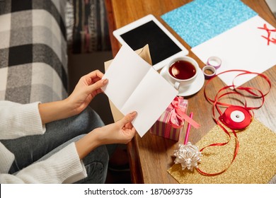 Comfortable. Close Up Female Hands Opening, Recieving Greeting Card For New Year And Christmas 2021 From Friends Or Family. Reading A Letter With Best Wishes, Opening Envelope. Holidays, Celebration.