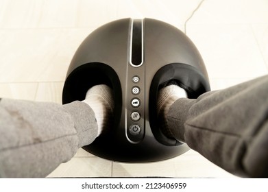 Comfortable Electric Foot Massager Stands Near The Rocking Chair At Home. Massage Concept.relaxation Foot Massage.