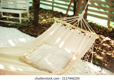 Comfortable Hammock With Pillow Hanging On Tree. Concept Of Recreation Outdoor. Hammock In Boho Style. White Hammock And Pillow For Relaxation In The Backyard Garden Shade On A Summer Afternoon. 