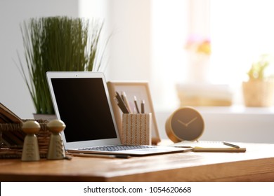 Comfortable home workplace with laptop on table