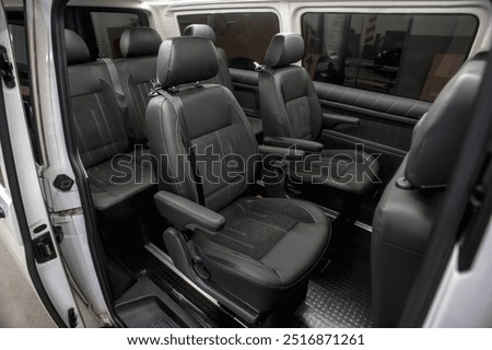 Comfortable interior of a passenger bus with soft seats. The design is made to order. Private covering of cars. Various elements of the bus interior.