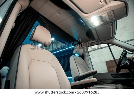Comfortable interior of a passenger bus with soft seats. The design is made to order. Private covering of cars. Various elements of the bus interior.