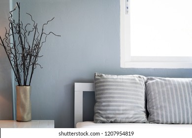 comfortable living room, grey pillow on sofa with window, copy space. Stock Photo