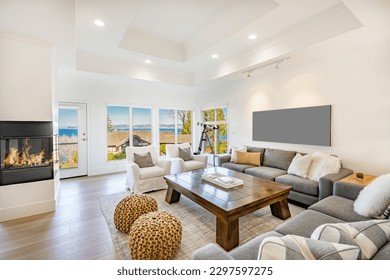 comfortable living room with grey sofa white shabby chic armchairs jute ottoman mirrors on the wall fireplace view to ocean and blue skies - Shutterstock ID 2297597275