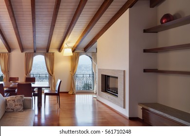 Comfortable, loft, detail living room with a fireplace and dining table, wooden floor