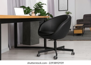 Comfortable office chair near desk in modern workplace - Shutterstock ID 2293892939