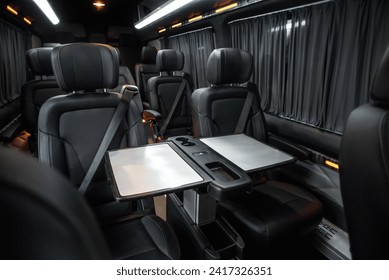 comfortable passenger bus interior with upholstered seats; individual transfer for a group of people; conversion of the interior of a truck;