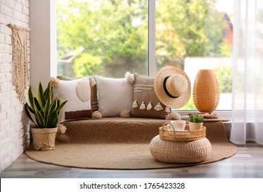 Comfortable place for rest with cushions near window indoors - Powered by Shutterstock