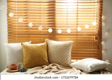 Comfortable place for rest with cushions on window sill - Powered by Shutterstock