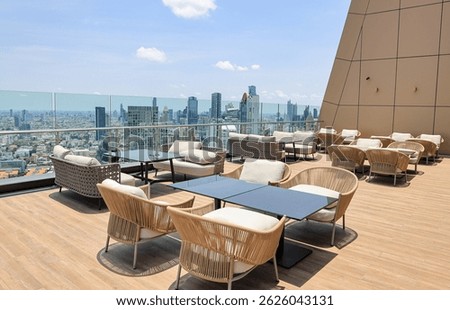 Comfortable seating area on top of a skyscraper, Service area on rooftop bar and restaurant area with beautiful cityscape view.