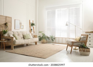 Comfortable sofa and armchair in stylish living room. Interior design - Shutterstock ID 2038825997