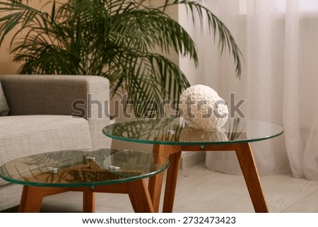 Comfortable sofa with coffee table in interior of living room