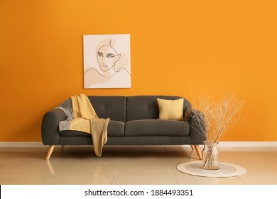 Comfortable Sofa Near Color Wall In Room